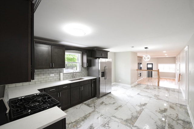 kitchen with a sink, marble finish floor, baseboards, backsplash, and stainless steel refrigerator with ice dispenser