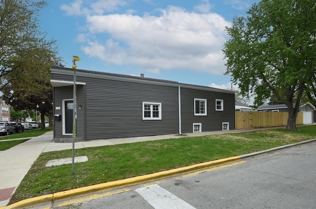 view of side of property with a yard and fence