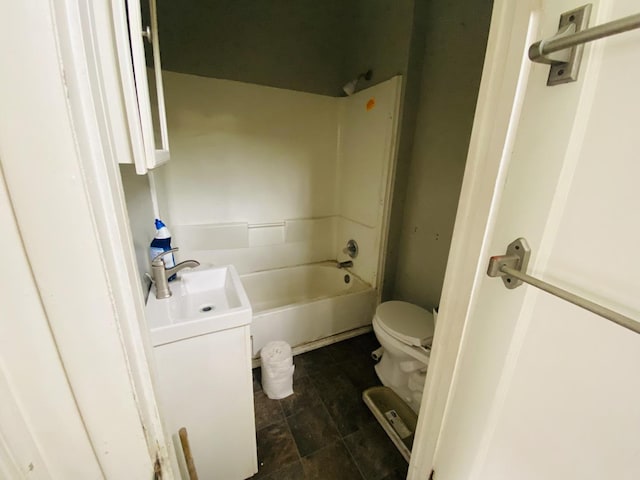 bathroom featuring toilet, shower / bathing tub combination, and vanity