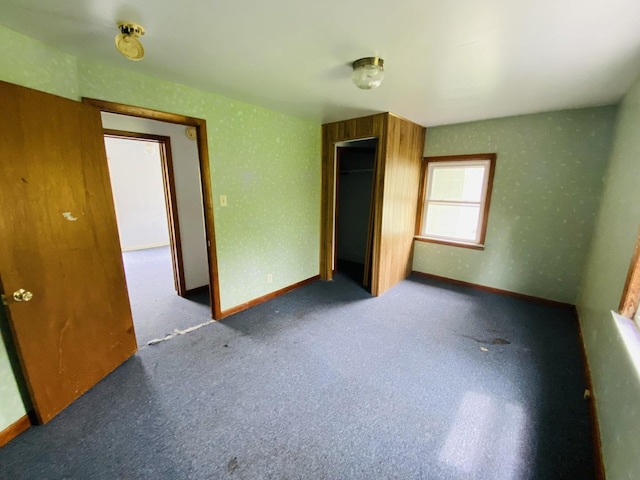 unfurnished bedroom with baseboards, a closet, and carpet