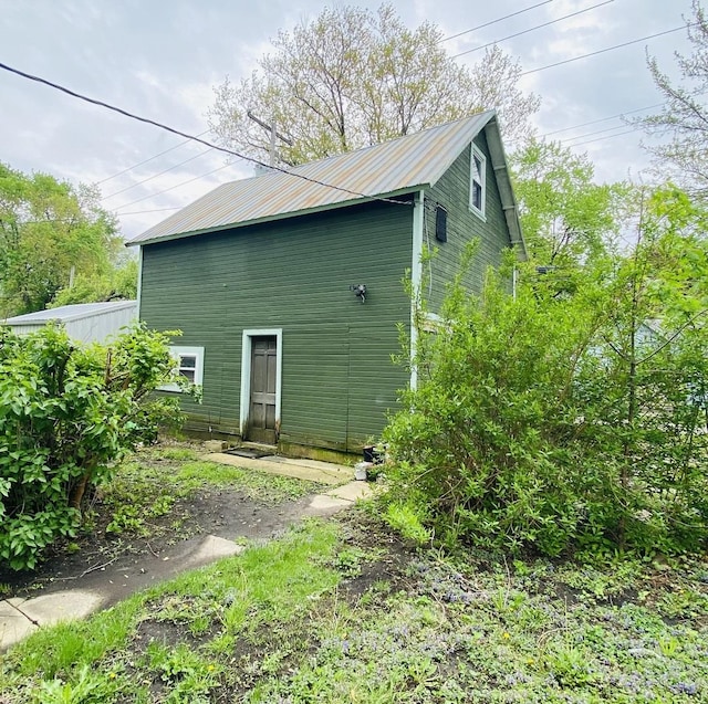 view of side of property with metal roof