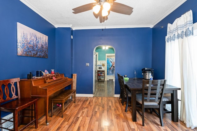 37 Mckinley Ave, Steger, IL 60475 - dining room with a textured ceiling, ceiling fan, wood finished floors, arched walkways, and ornamental molding