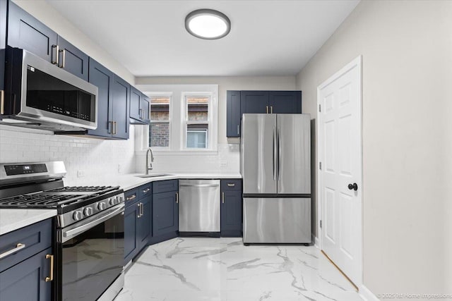 kitchen with appliances with stainless steel finishes, tasteful backsplash, a sink, light countertops, and marble finish floor