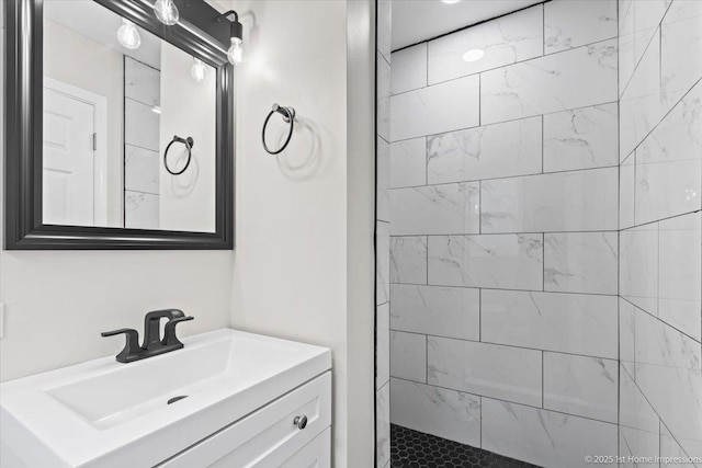 full bathroom featuring vanity and a tile shower