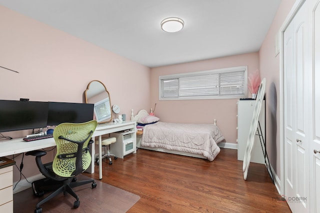 bedroom featuring baseboards and wood finished floors