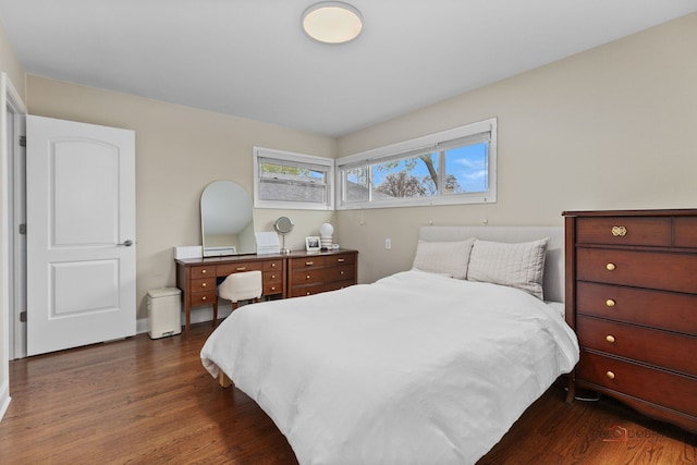 bedroom with dark wood finished floors