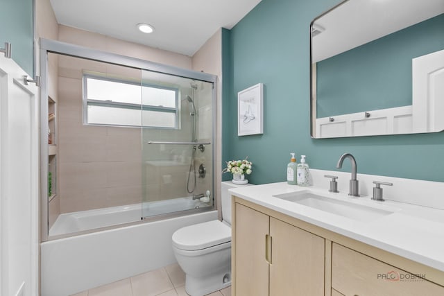 bathroom with tile patterned flooring, enclosed tub / shower combo, toilet, and vanity