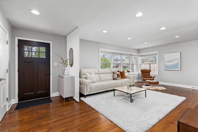 living room featuring recessed lighting, baseboards, and dark wood-type flooring