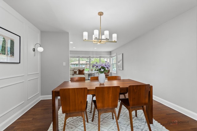 dining room with recessed lighting, baseboards, wood finished floors, and a notable chandelier