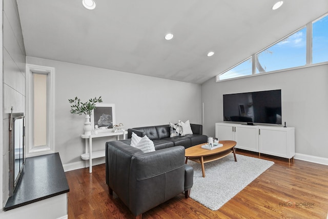 living room featuring recessed lighting, baseboards, lofted ceiling, and wood finished floors