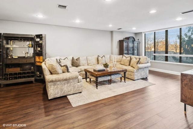 living area with recessed lighting, wood finished floors, and visible vents