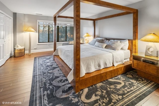 bedroom featuring baseboards and wood finished floors