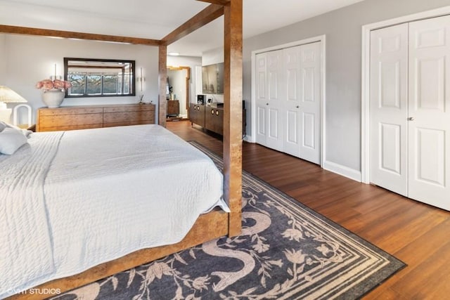 bedroom with baseboards and wood finished floors