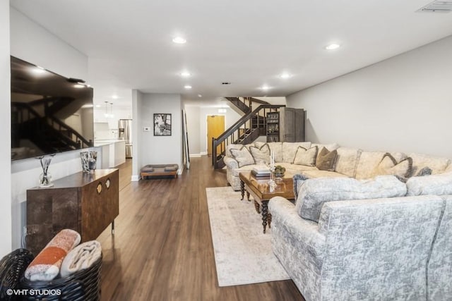 living room with stairway, recessed lighting, dark wood finished floors, and visible vents
