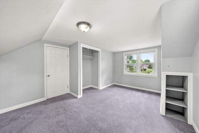 additional living space with carpet floors, baseboards, and vaulted ceiling