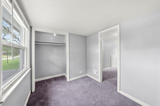 unfurnished bedroom with visible vents, carpet, baseboards, and a closet