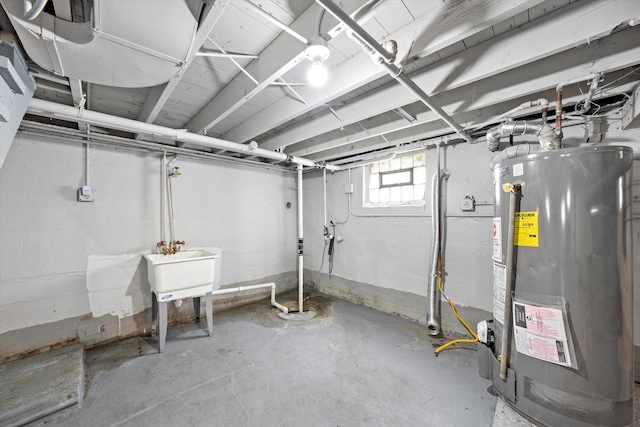 below grade area with a sink and gas water heater