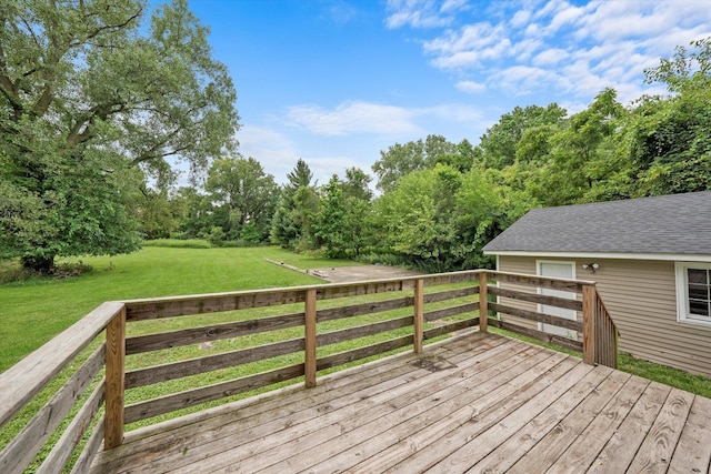 wooden terrace featuring a lawn