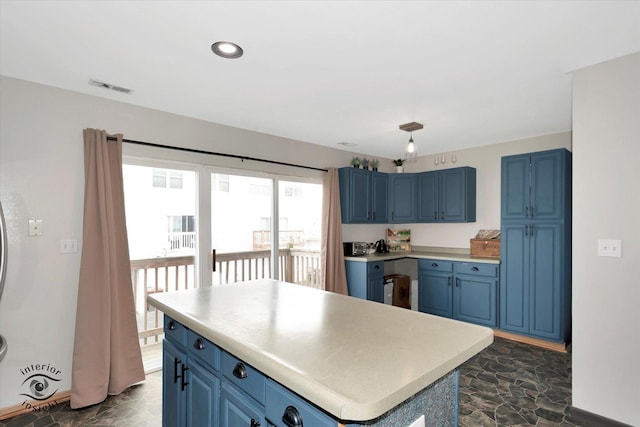 1372 Fox Hound Trl, Beecher, IL 60401 - kitchen featuring blue cabinetry, light countertops, a center island, and baseboards