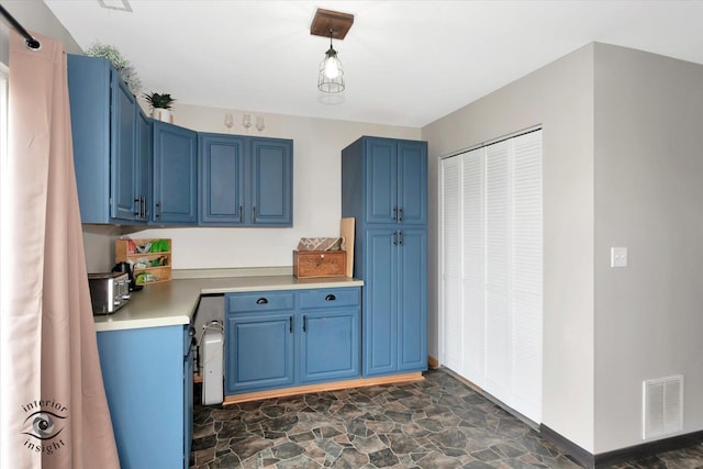 1372 Fox Hound Trl, Beecher, IL 60401 - kitchen with blue cabinetry, light countertops, dark stone finish flooring, and baseboards