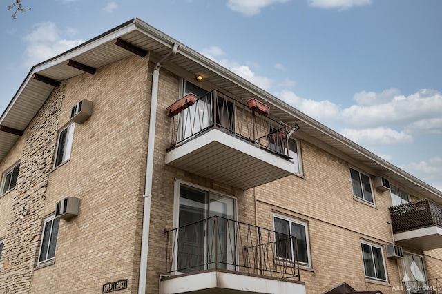 view of building exterior featuring a wall mounted air conditioner