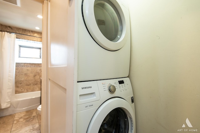 washroom featuring laundry area and stacked washer and dryer
