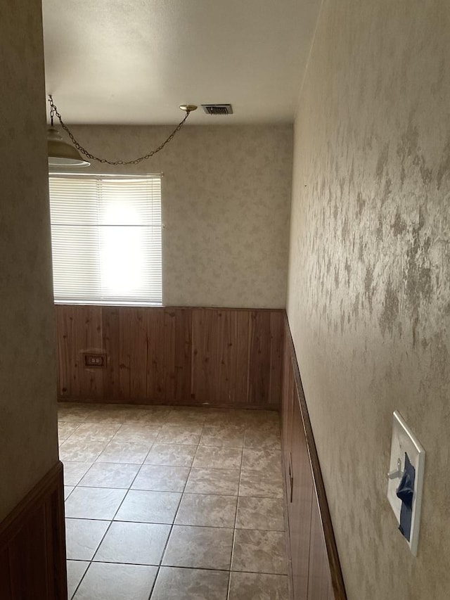 3010 Bernice Rd Unit 104, Lansing, IL 60438 - empty room with light tile patterned flooring and wooden walls