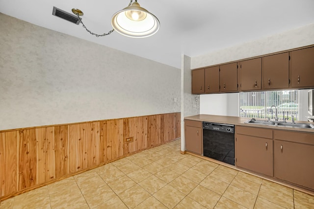 3010 Bernice Rd Unit 104, Lansing, IL 60438 - kitchen with black dishwasher, a wainscoted wall, wood walls, and light countertops
