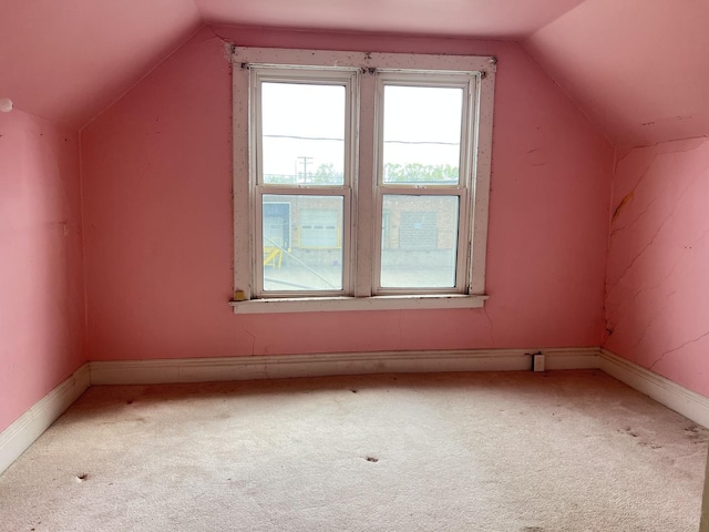 additional living space with carpet floors, baseboards, and lofted ceiling
