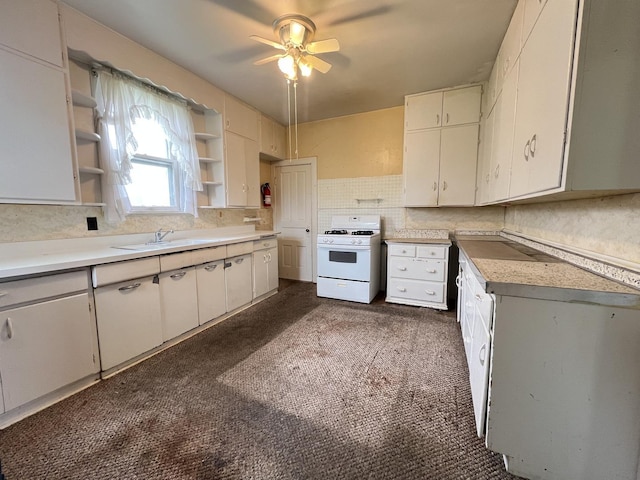 kitchen featuring open shelves, a ceiling fan, white gas range, light countertops, and a sink