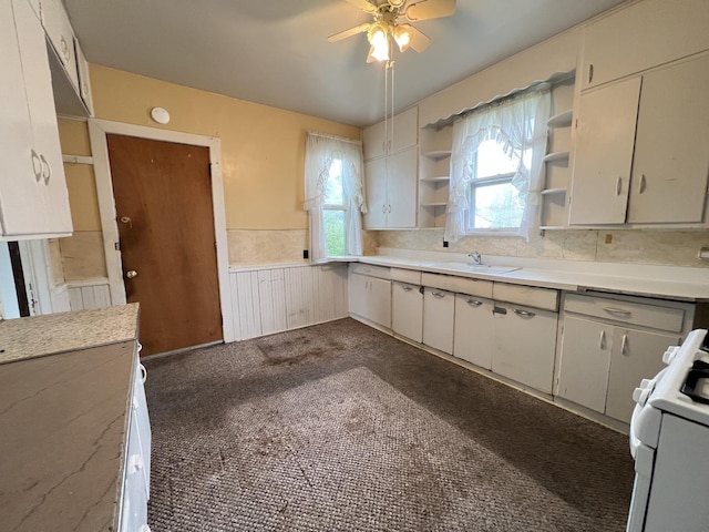 kitchen with a ceiling fan, open shelves, a sink, light countertops, and white range with gas stovetop