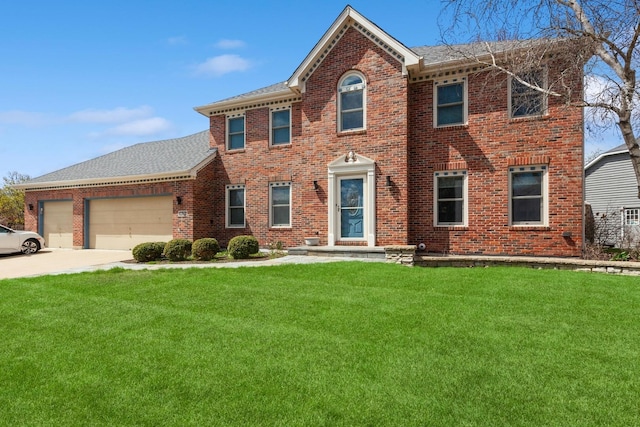 colonial home with driveway, a front lawn, and brick siding