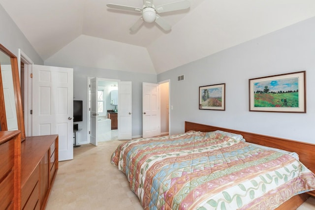 bedroom with visible vents, light carpet, a ceiling fan, ensuite bath, and vaulted ceiling