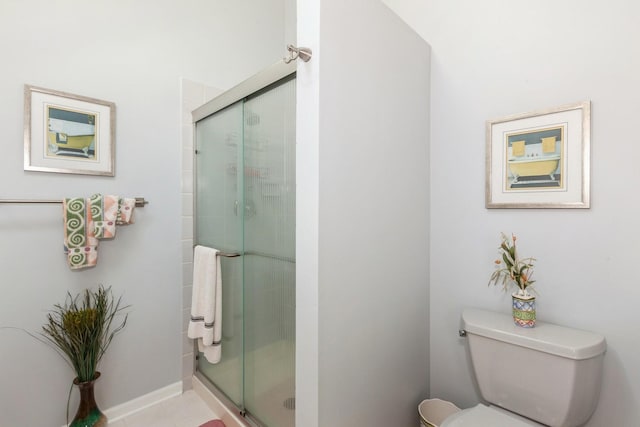 bathroom with toilet and a stall shower