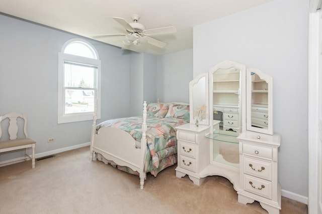 bedroom featuring baseboards, light carpet, and ceiling fan