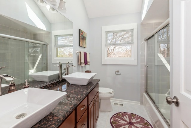 bathroom featuring tile patterned floors, visible vents, and a sink