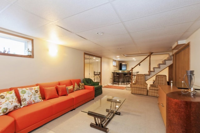 living room with a bar, a paneled ceiling, carpet floors, and stairway