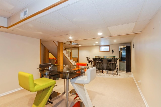 carpeted dining space with a dry bar, stairs, recessed lighting, baseboards, and visible vents