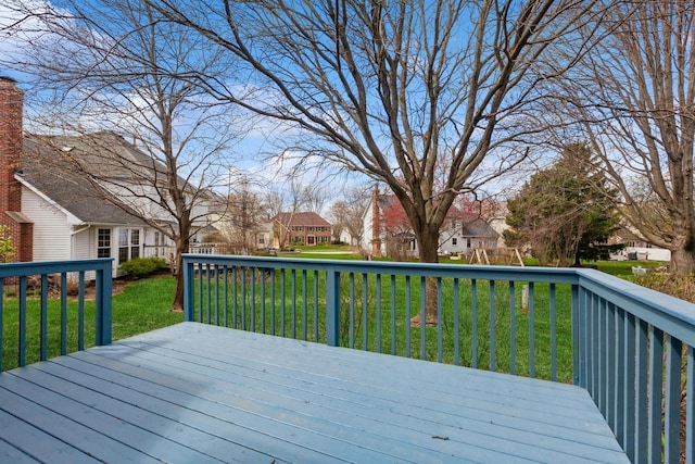 wooden deck featuring a yard and a residential view
