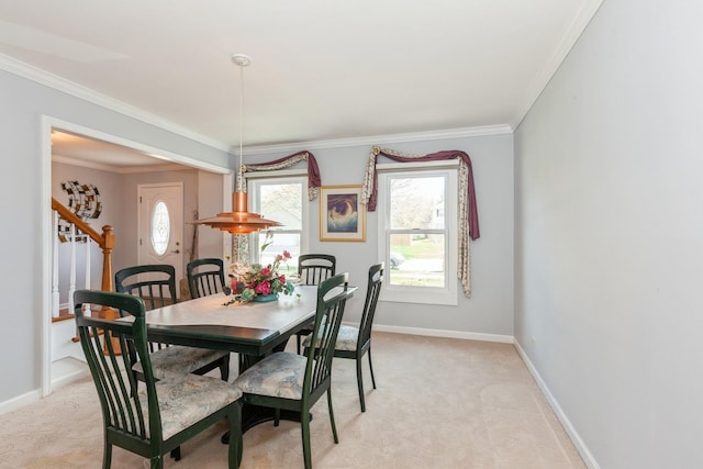 dining area with baseboards, ornamental molding, stairs, and light colored carpet