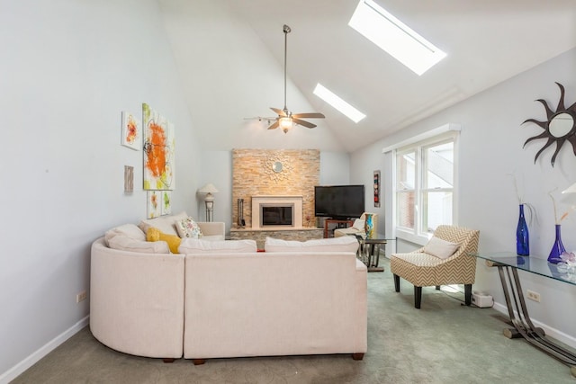 living room featuring a skylight, a fireplace, high vaulted ceiling, baseboards, and carpet