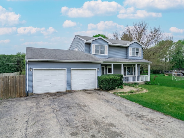 view of front facade with fence, a garage, a front yard, covered porch, and driveway