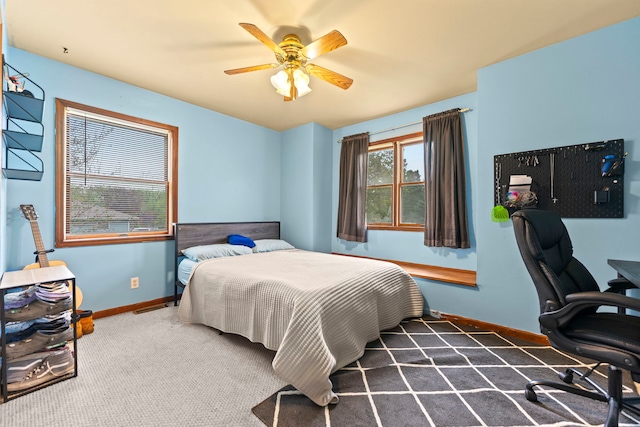 carpeted bedroom with baseboards and ceiling fan