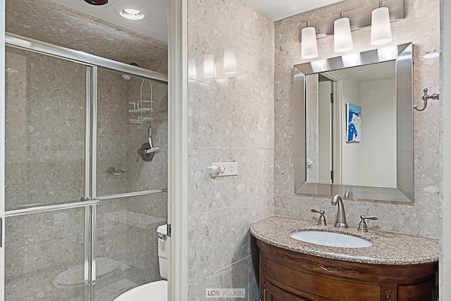 175 E Delaware Pl Unit 5019, Chicago, IL 60611 - bathroom with a stall shower, vanity, tile walls, and toilet