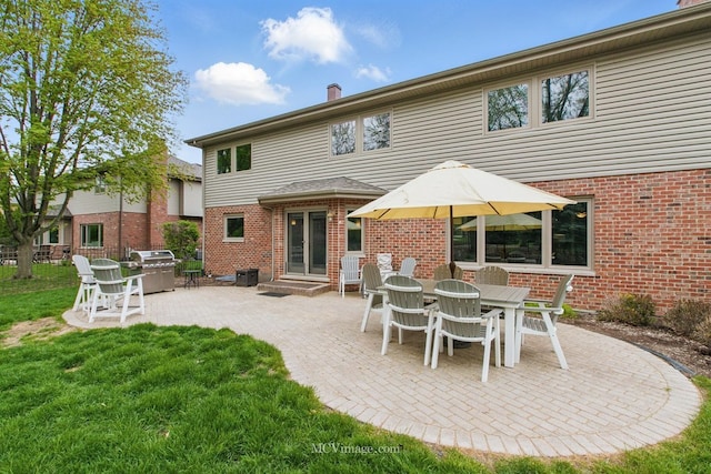 12652 Suffield Dr, Palos Park, IL 60464 - rear view of property featuring a yard, brick siding, a chimney, and a patio area