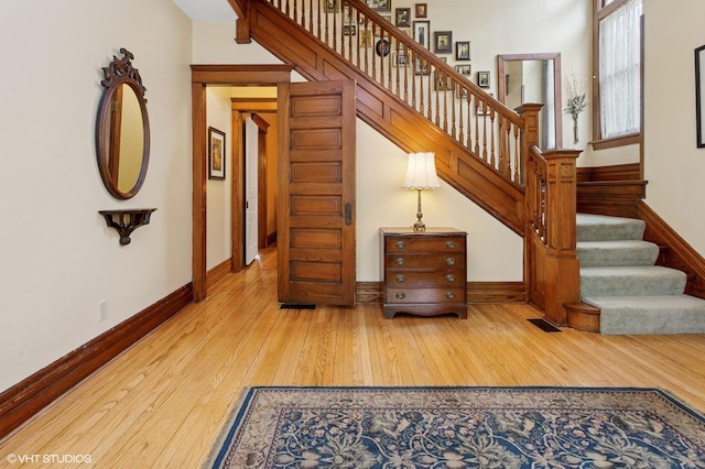 317 Augusta Ave, Dekalb, IL 60115 - staircase featuring baseboards, visible vents, and hardwood / wood-style flooring