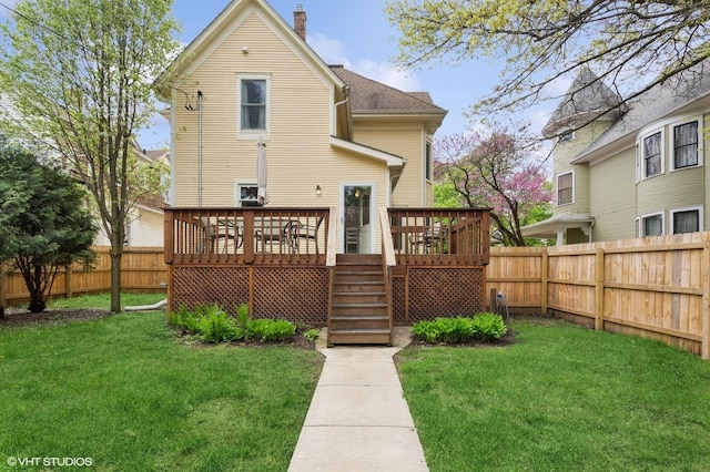 317 Augusta Ave, Dekalb, IL 60115 - rear view of house with a chimney, a deck, a lawn, a fenced backyard, and stairs