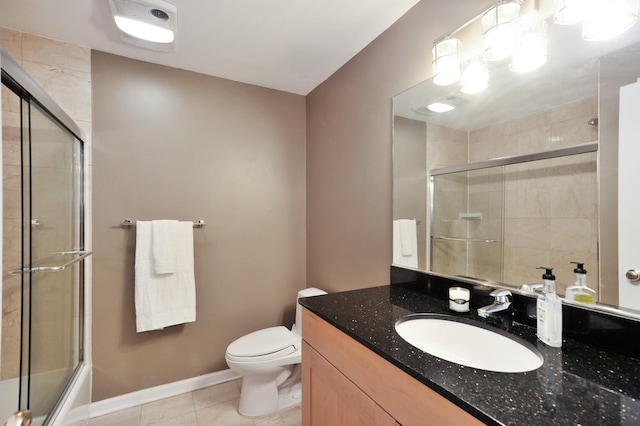 1521 N Ashland Ave Unit 2, Chicago, IL 60622 - bathroom with tile patterned floors, vanity, toilet, baseboards, and bath / shower combo with glass door