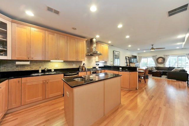 1521 N Ashland Ave Unit 2, Chicago, IL 60622 - kitchen featuring wall chimney exhaust hood, a sink, a peninsula, light wood-style floors, and recessed lighting