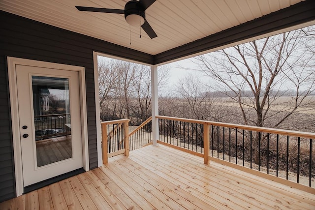 wooden deck with a ceiling fan